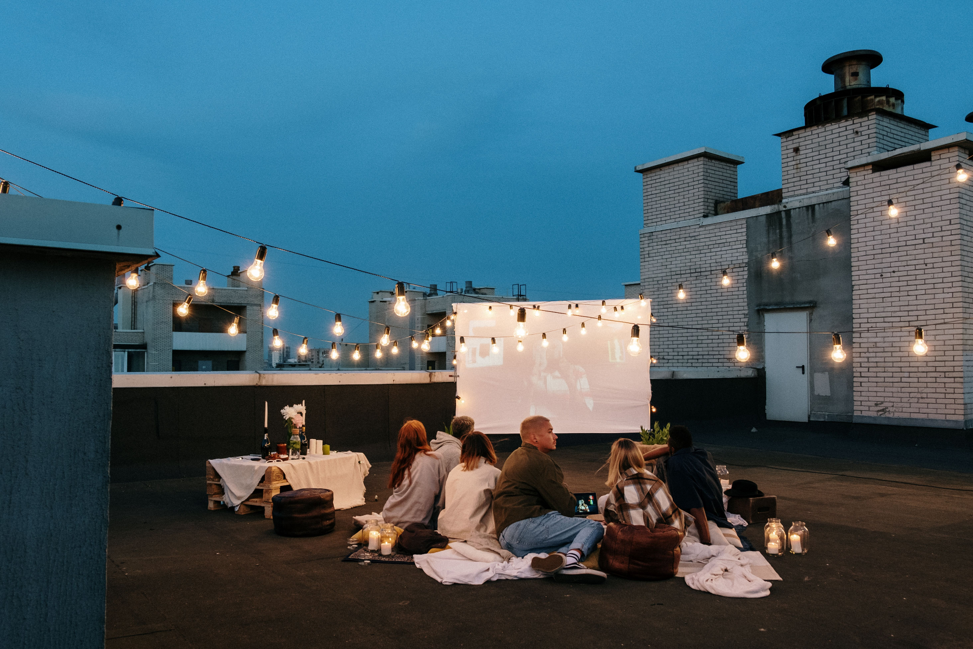 Open-air rooftop cinema with string lights